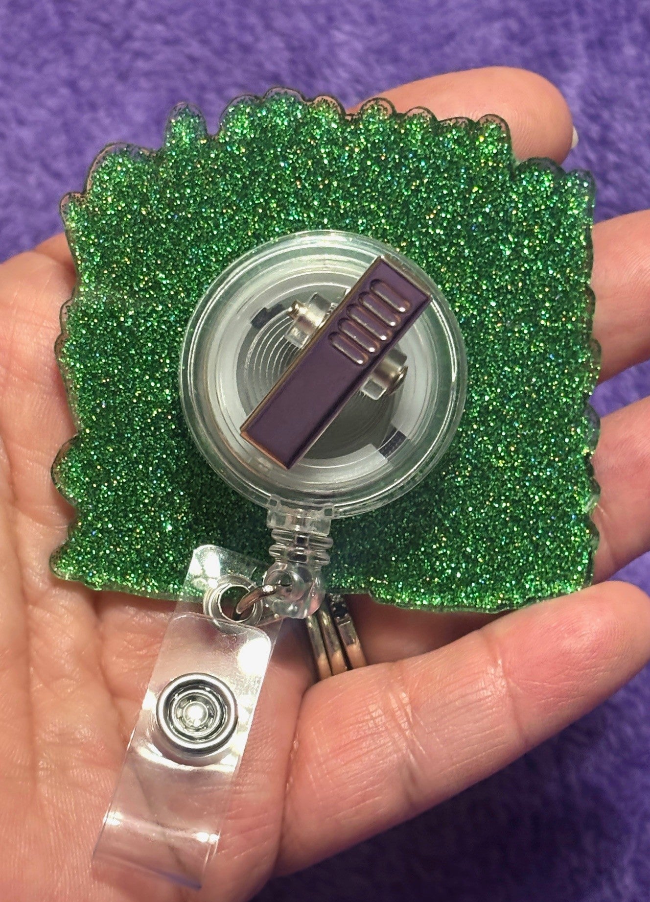 Cow in the field of Flowers Badge Reel