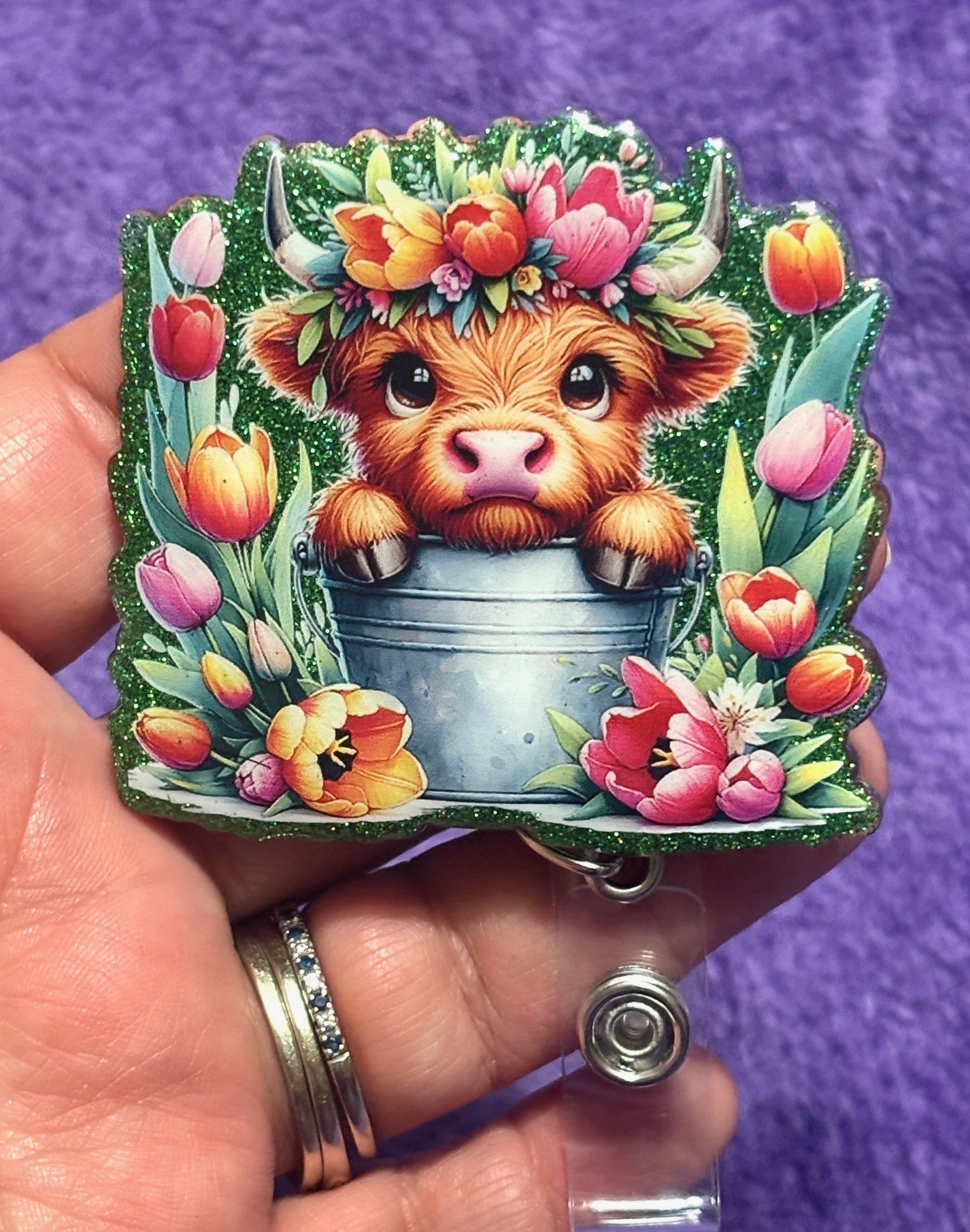 Cow in the field of Flowers Badge Reel