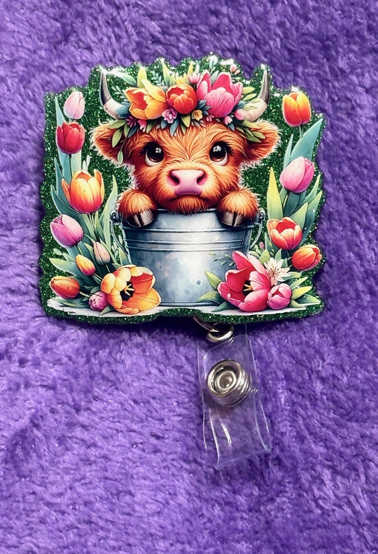 Cow in the field of Flowers Badge Reel