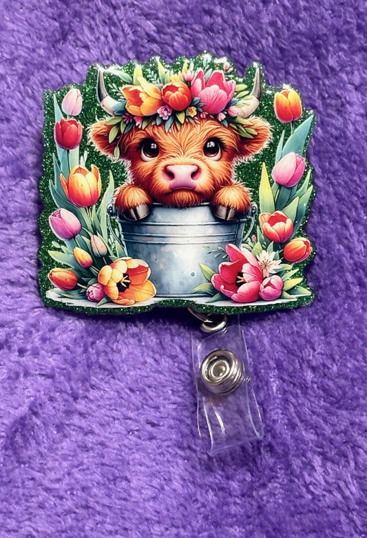 Cow in the field of Flowers Badge Reel